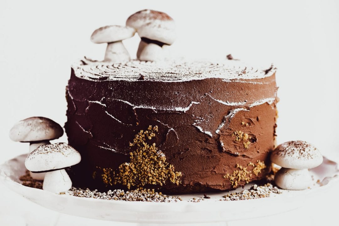 buche de noel layer cake on a cake stand with meringue mushrooms - 2