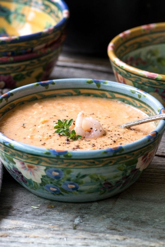 Creamy shrimp bisque soup in a floral bowl.