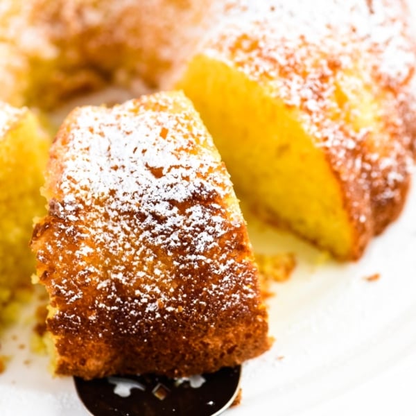 removing a slice of orange cake with a cake server