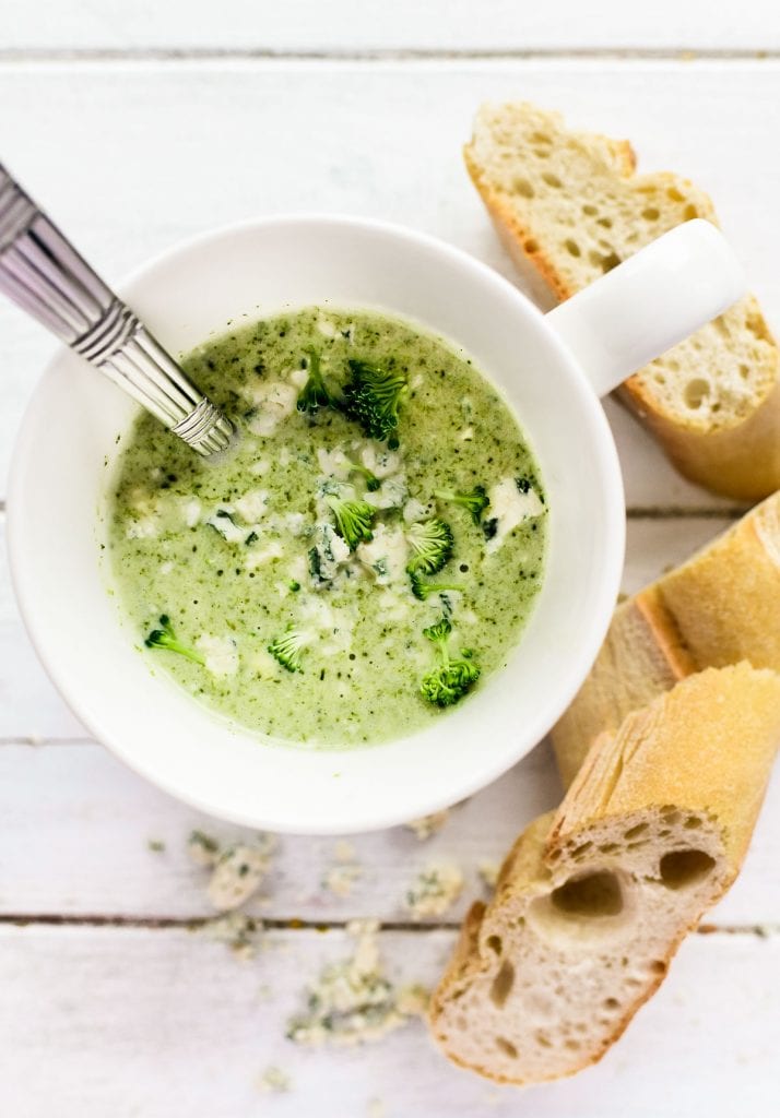 a mug of broccoli Stilton soup with baguette