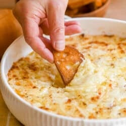Dipping toasted bread into a baked Vidalia onion dip.