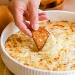 Dipping toasted bread into a baked Vidalia onion dip.