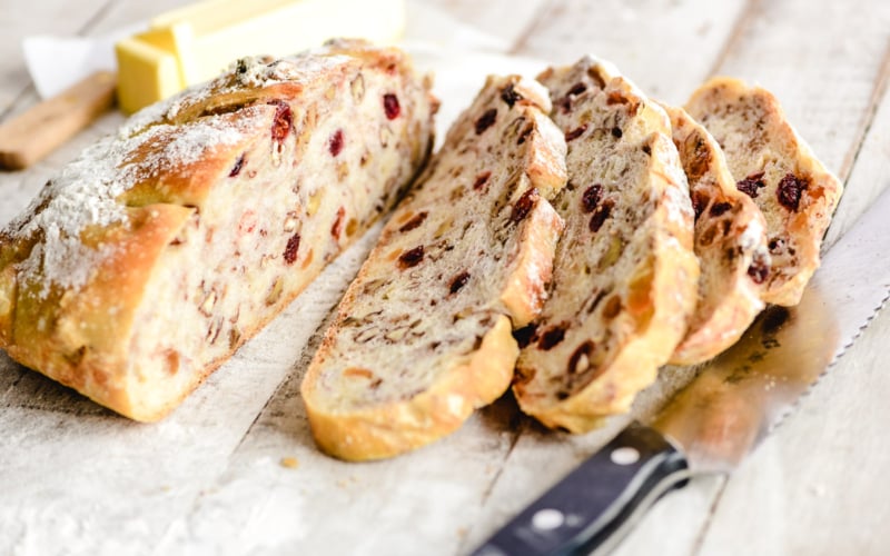 no knead trail mix bread, sliced on a floured board
