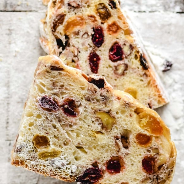 slices of fruit and nut bread on a floured board