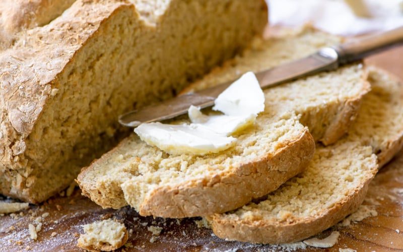 Irish Oatmeal Soda Bread with knife and soft butter.