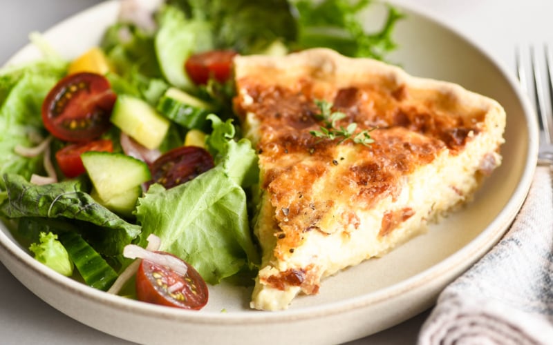 Quiche Lorraine on a plate with salad