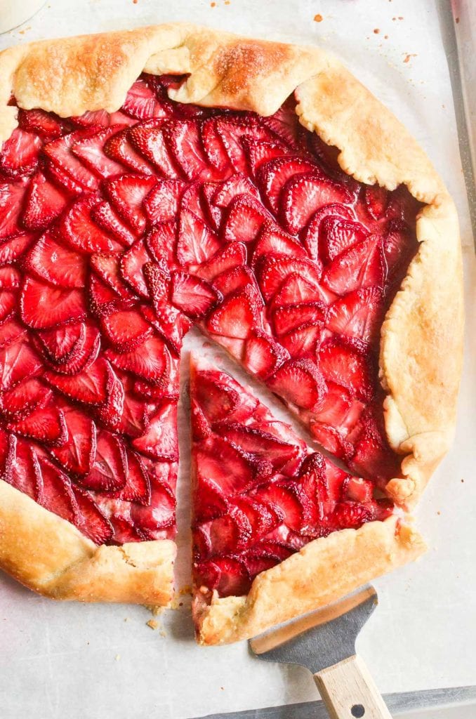 strawberry tart being sliced and served.