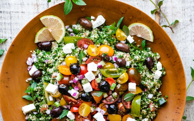 loaded tabbouleh salad in a wooden bowl