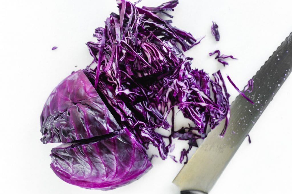 slicing red cabbage for Thai chicken salad.