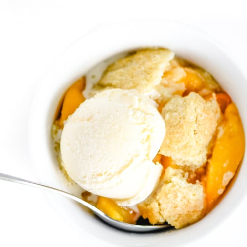 peach cobbler with a scoop of ice cream