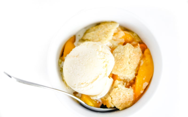 peach cobbler with a scoop of ice cream
