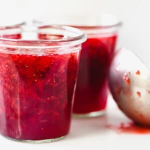 Jars of homemade Sure-Jell strawberry jam, ready to can.