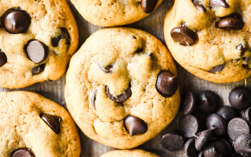chocolate chip pumpkin cookies, with dark chocolate chips on a wooden board