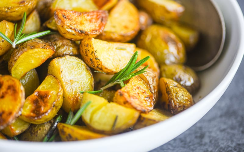 oven roasted potatoes with rosemary in a bowl