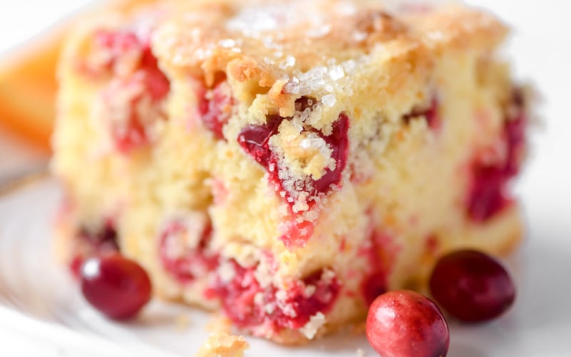 a slice of cranberry orange snack cake