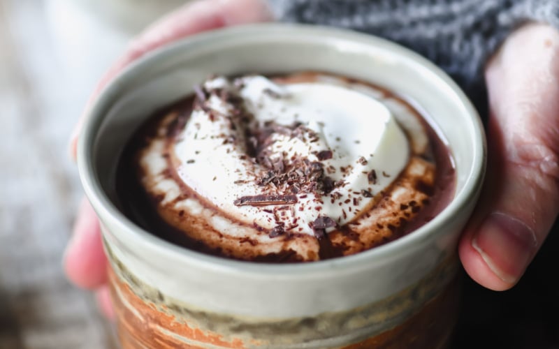 holding a cup of drinking chocolate