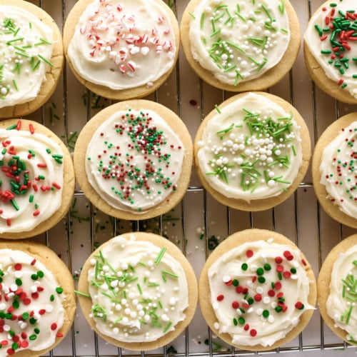 frosted cookies with sprinkles on a cooling rack