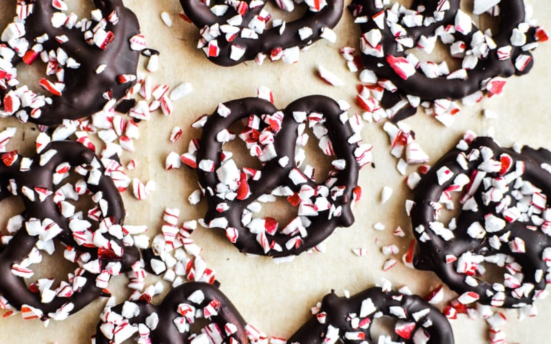 Cooled peppermint bark pretzels on a piece of parchment paper.