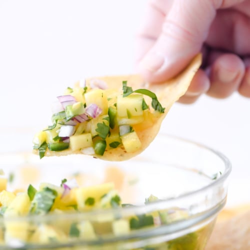 scooping pineapple salsa