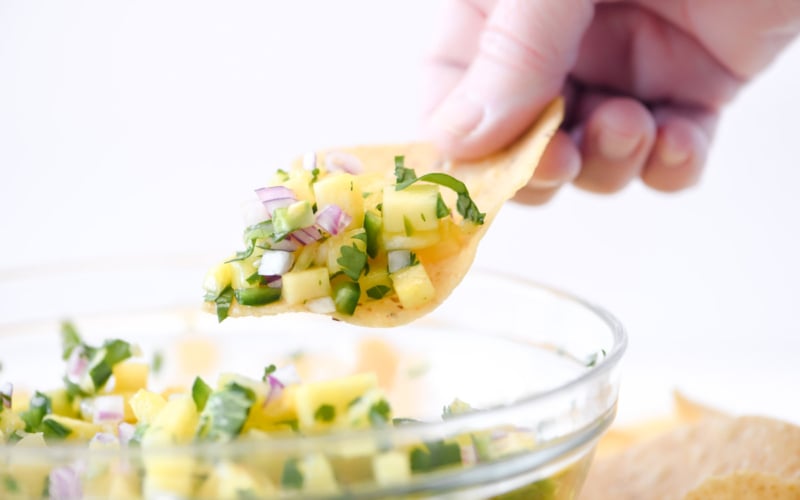 scooping pineapple salsa
