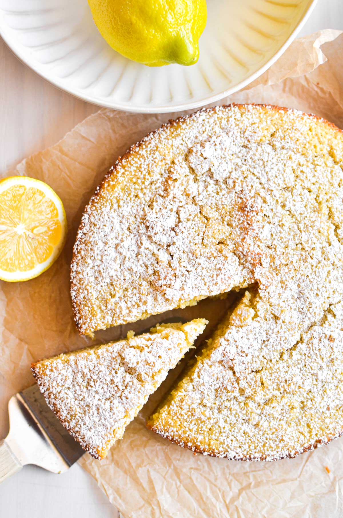 taking a slice of lemon olive oil cake