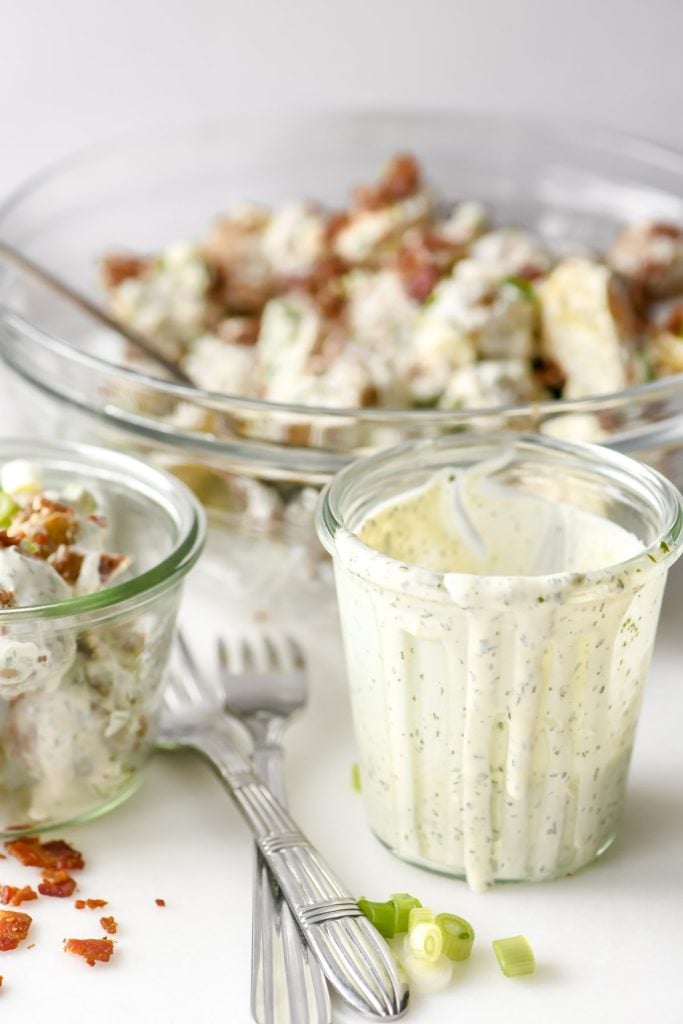 ranch dressing in a jar with ranch potato salad in a bowl