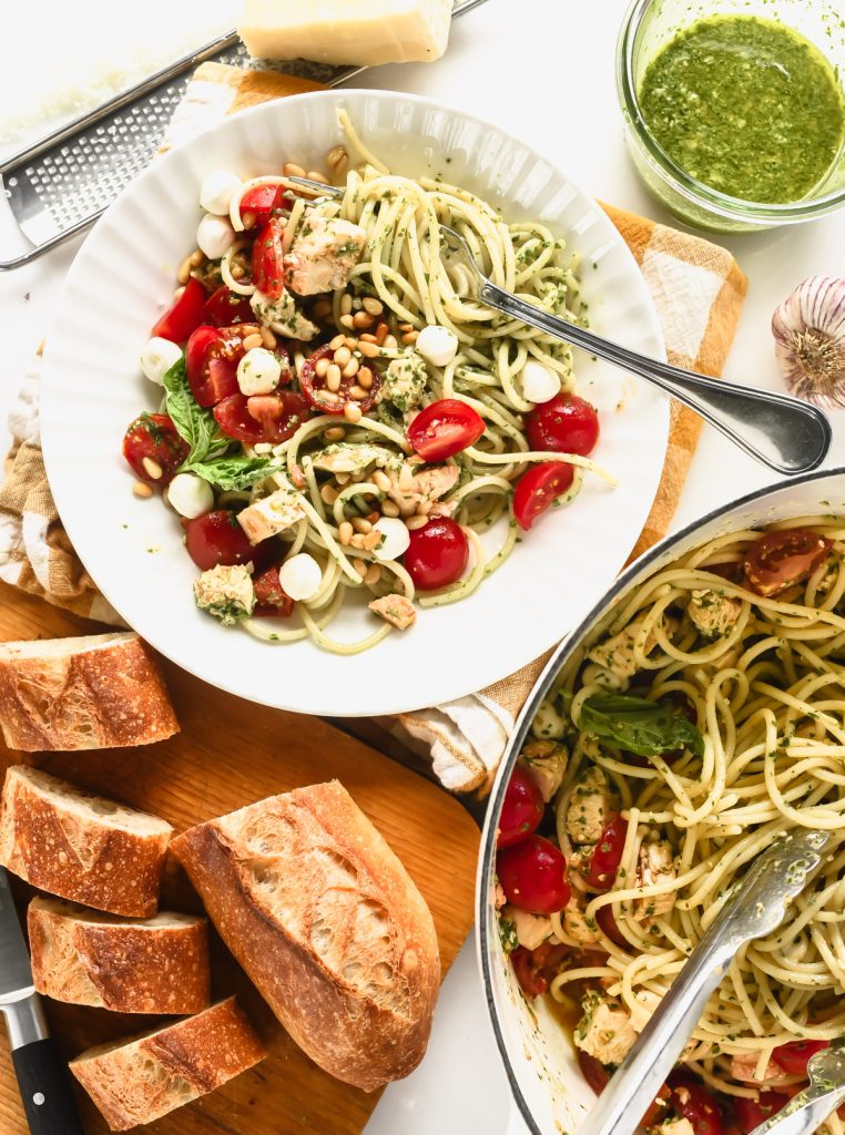 Chicken Margarita pasta in a bowl with bread and pesto