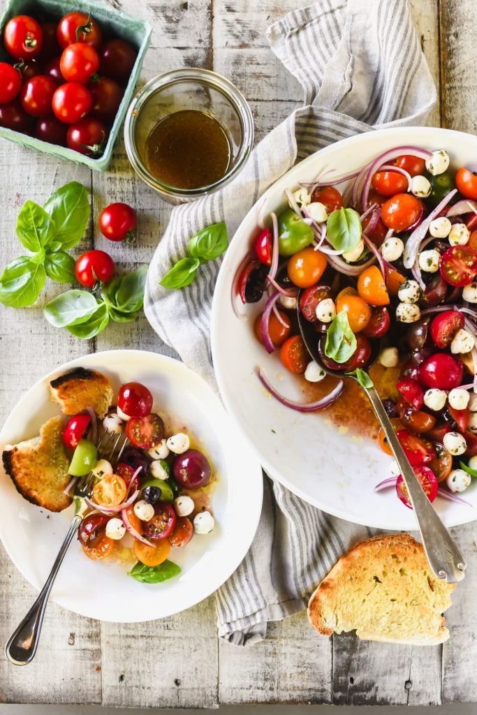 cherry tomato caprese salad in white bowls.