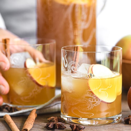 making mezcal cocktails with a bowl of apples