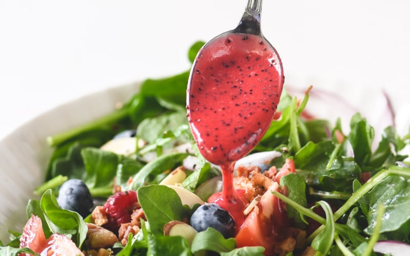raspberry poppy seed dressing on a spoon