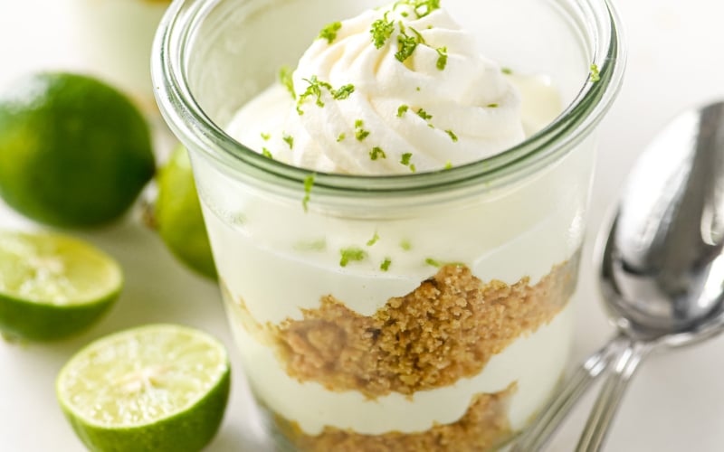 key lime parfait in a small jar with key limes