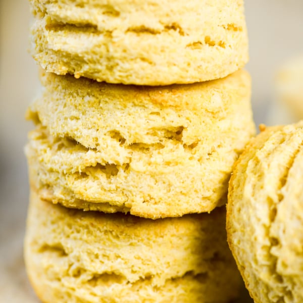 cornmeal biscuits, stacked on a cooling rack.