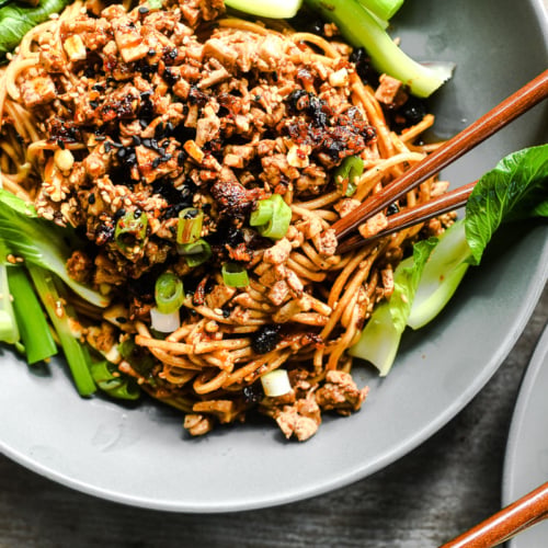 vegan dan dan noodles with scallions and bok choy.