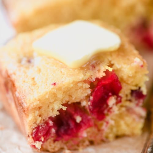 Cranberry shortbread with a pat of butter melting on top.