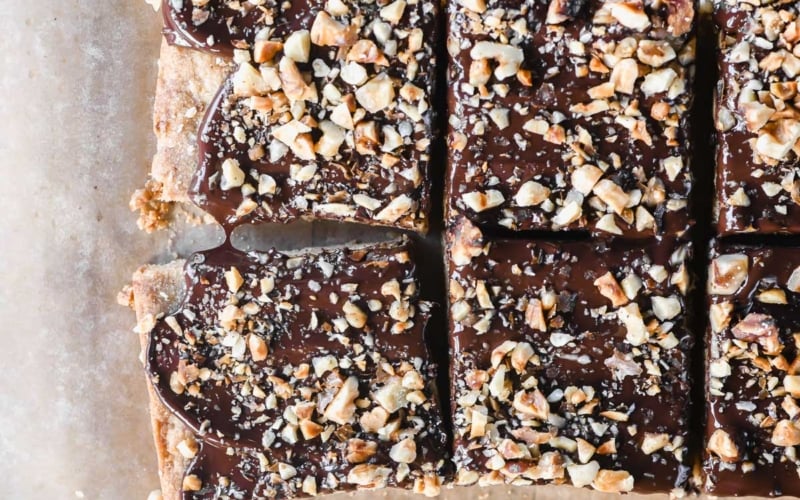 Toffee bars sliced, on parchment paper.