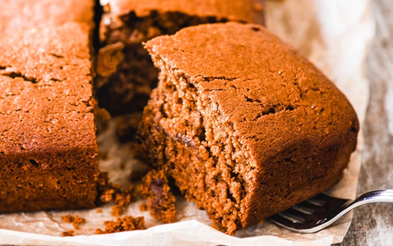 Taking a slice of gingerbread cake with a fork.