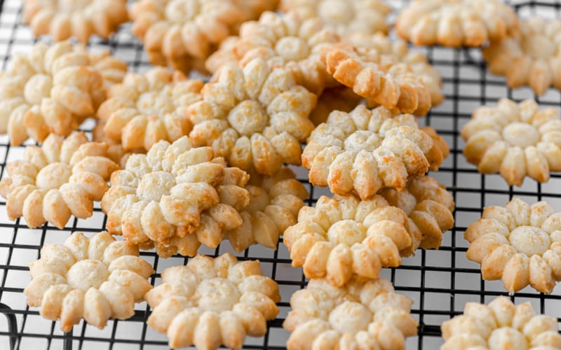 Gruyere cheese spritz crackers on a cooling rack.