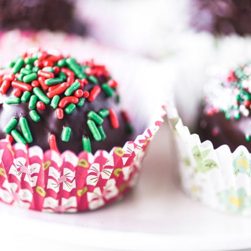 hot chocolate bombs with colorful holiday sprinkles.