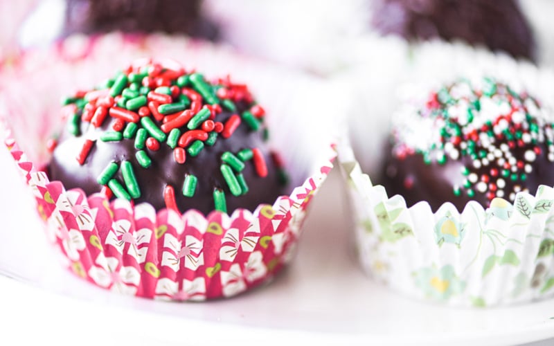 hot chocolate bombs with colorful holiday sprinkles.