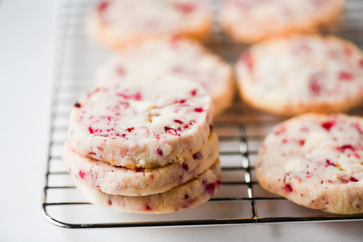 cranberry white chocolate cookies on a cooling rack.