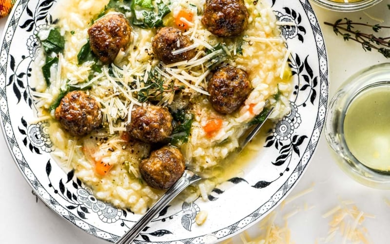 Italian Wedding Risotto in a shallow bowl with Parmesan cheese.