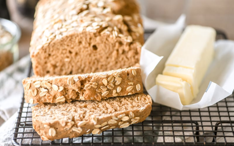 Guinness bread on a cooling rack with butter.