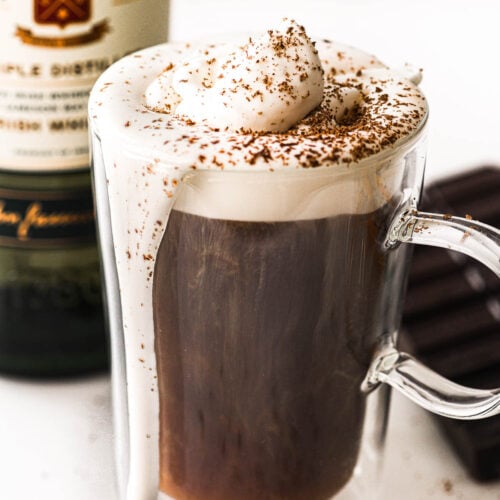 Irish Coffee in a glass mug with whipped cream.