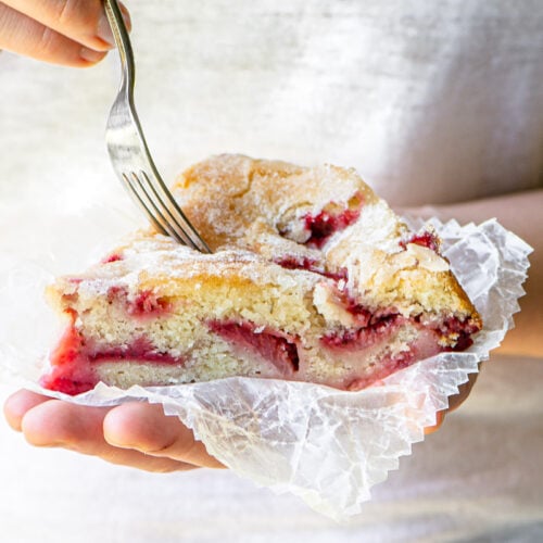 Girl holding a fork and a piece of strawberry buttermilk cake.