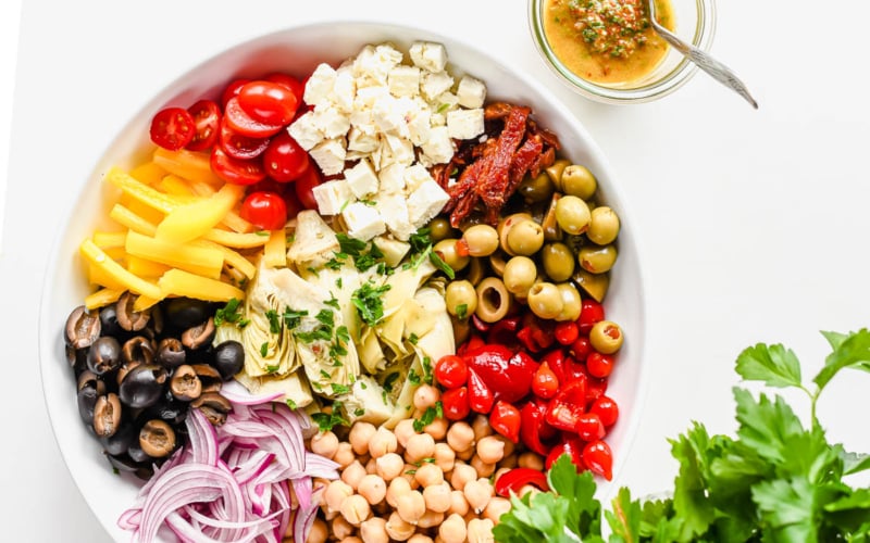 Mediterranean artichoke salad in a bowl with dressing.