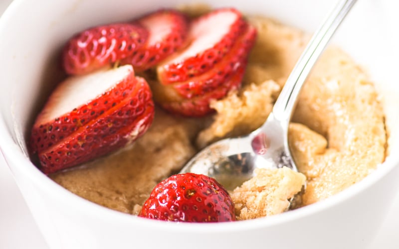 protein pancake bowl with strawberries and maple syrup.