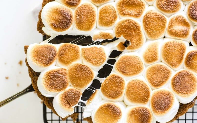 s'mores pie with piece being taken with a pie server.