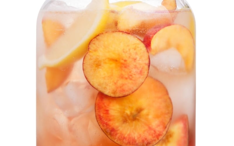 Fresh peach lemonade in a large glass jug.