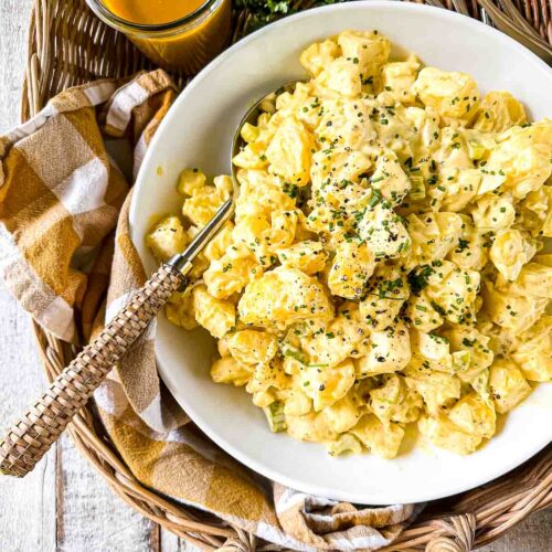 Carolina Gold Barbecue Potato Salad in a bowl with barbecue sauce.