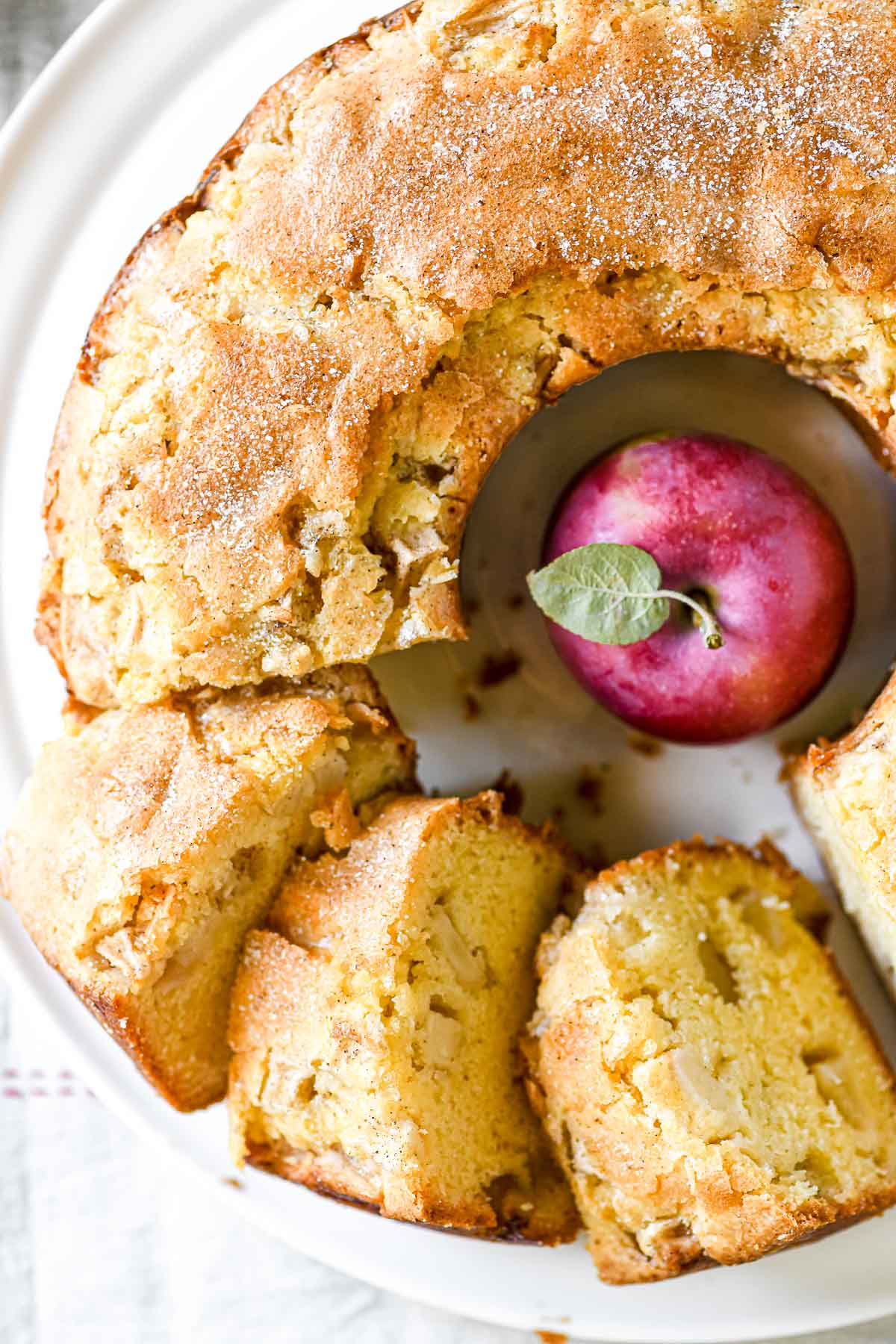 Jewish apple cake on a plate, sliced.